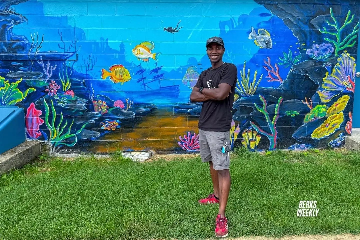 Jean Esther in front of an underwater mural