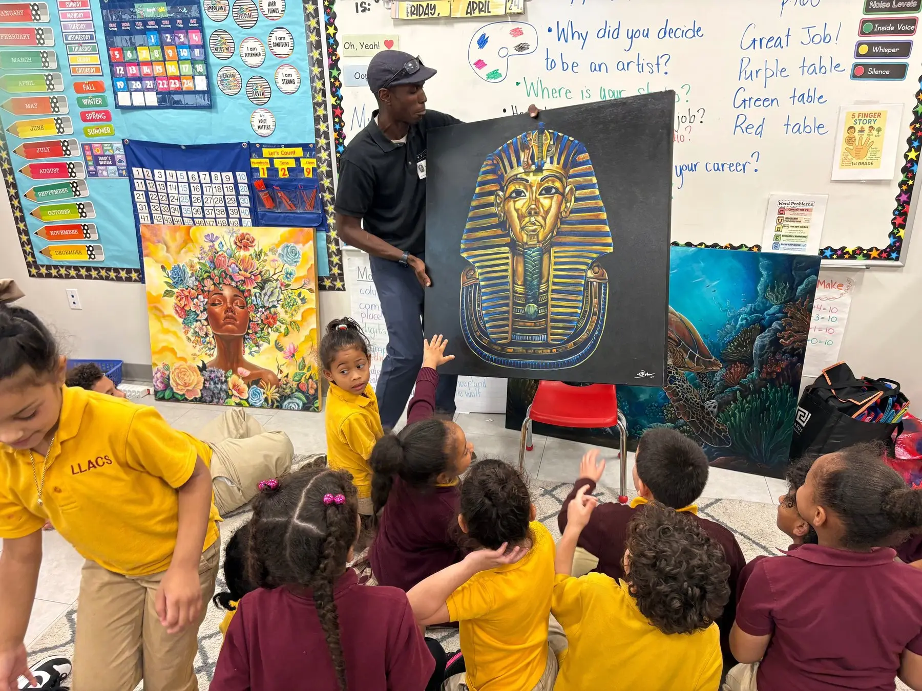 Jean Esther showing a painting to a class